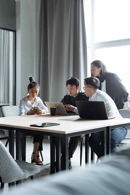 A group of four individuals in a modern office setting